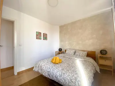 a bedroom with a bed with a yellow stuffed animal on it at Renovado y sofisticado en el centro de Valencia in Valencia