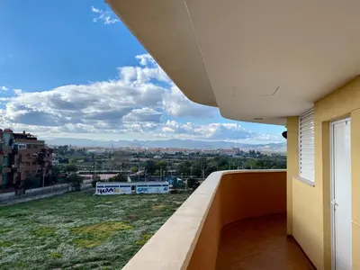 a balcony with a view of a city at Urbanización Mar de Canet, 2 dormitorios con piscina comunitaria, garaje y wifi in Canet de Berenguer