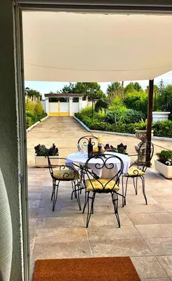 a table and chairs sitting under an umbrella on a patio at LEMON TREE VILLA in Monserrat