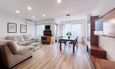 a living room with a couch and a table at Lovely 3-Bedroom Apartment 15 Minutes from Beach in Valencia