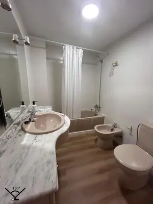 a white bathroom with a sink and a toilet at Lovely 3-Bedroom Apartment 15 Minutes from Beach in Valencia