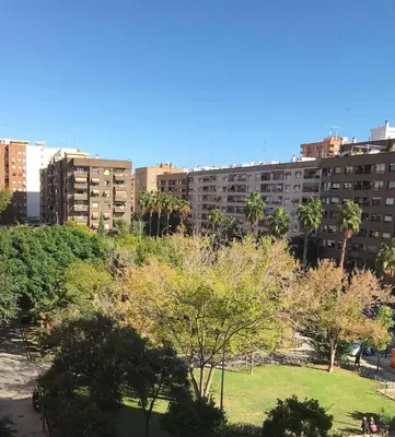 a park in the middle of a city with tall buildings at Lovely 3-Bedroom Apartment 15 Minutes from Beach in Valencia