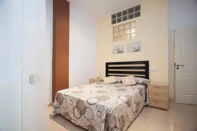 a bedroom with a bed and a wooden dresser at Casita privada con encanto en la playa de Valencia in Valencia