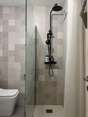 a bathroom with a glass shower with a toilet at Casita privada con encanto en la playa de Valencia in Valencia
