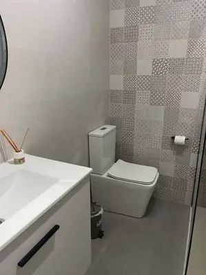 a bathroom with a white toilet and a sink at Casita privada con encanto en la playa de Valencia in Valencia