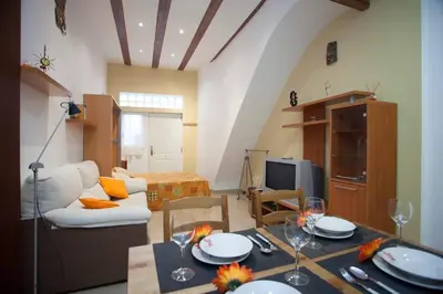 a living room with a table and a couch at Casita privada con encanto en la playa de Valencia in Valencia
