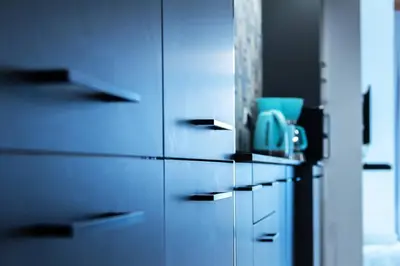 a row of blue cabinets in a kitchen at Chic estudio privado al lado de la playa in Valencia
