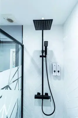 a shower in a bathroom with a black shower head at Chic estudio privado al lado de la playa in Valencia