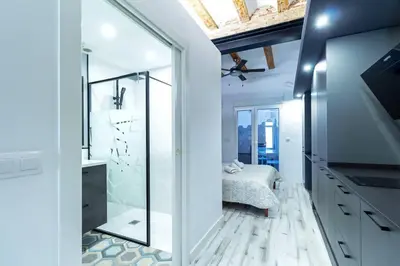 a bathroom with a walk in shower and a sink at Chic estudio privado al lado de la playa in Valencia