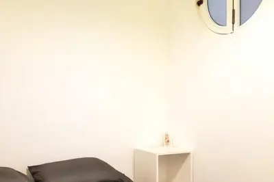 a room with a chair and a mirror on the wall at Cozy apartment with sea view in Valencia 100 m²! in Valencia