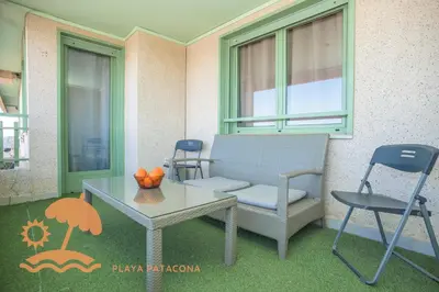 a table and a chair and a table and a table and chairs at Front Sun Beach Apartment in Valencia