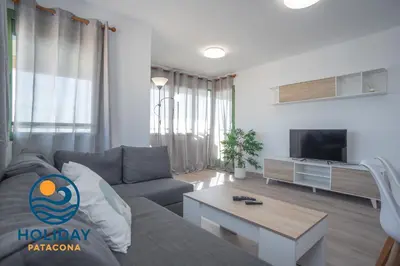 a living room with a couch and a tv at Front Sun Beach Apartment in Valencia