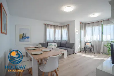 a living room with a table and a couch at Front Sun Beach Apartment in Valencia