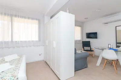 a living room with a white cabinet and a table at BET Apartments - Reig in Valencia