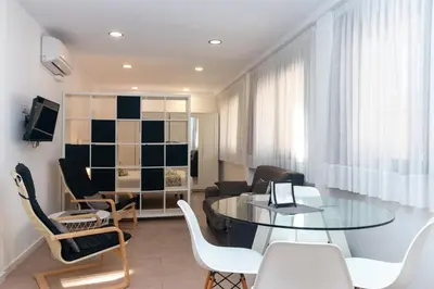 a living room with a glass table and chairs at BET Apartments - Reig in Valencia