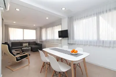 a living room with a table and chairs and a couch at BET Apartments - Reig in Valencia