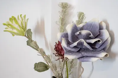 a vase with a flower on a wall at Versus Apartment City Center in Valencia