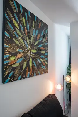 a painting hanging on a wall next to a couch at Versus Apartment City Center in Valencia