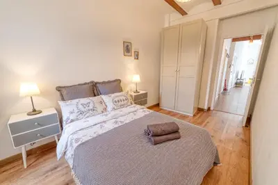a bedroom with a large bed and a hallway at Beams & Bricks in Valencia