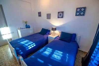 two beds in a room with blue sheets at Anna, embrujo de la naturaleza in Anna