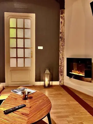 a living room with a table and a fireplace at València Experience Apartment in Valencia