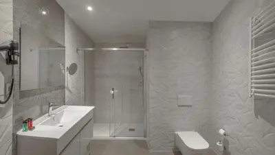 a bathroom with a shower and a sink and a toilet at SH Suite Palace in Valencia