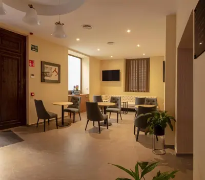 a waiting room with chairs and tables in a hospital at SH Suite Palace in Valencia