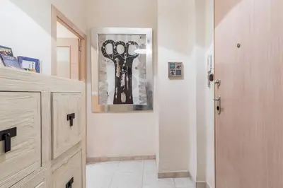 a hallway with a door and a painting on the wall at PRECIOSO APARTAMENTO EN EL BARRIO DE RUZAFA in Valencia