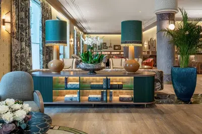 a lobby with a book shelf with books at Palacio Santa Clara, Autograph Collection in Valencia