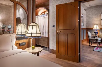 a bedroom with a bed and a table and a chair at Palacio Santa Clara, Autograph Collection in Valencia