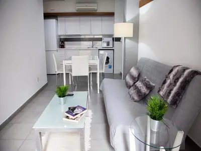 a living room with a couch and a table at Flats Friends Tetuan in Valencia