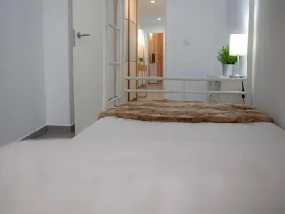 a white room with a bed with atained at Flats Friends Tetuan in Valencia