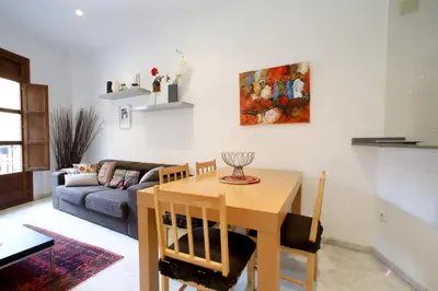 a living room with a table and a couch at Valencia Centro. Wifi/AACC Jacuzzi in Valencia