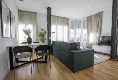 a living room with a couch and a table at Apartamentos San Vicente in Valencia