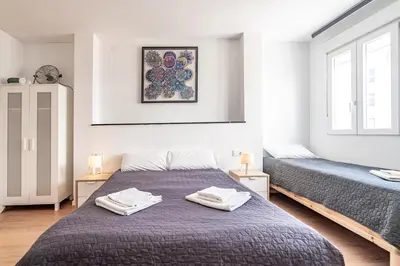 a bedroom with two beds with towels on them at Jardín Botánico Rooms in Valencia