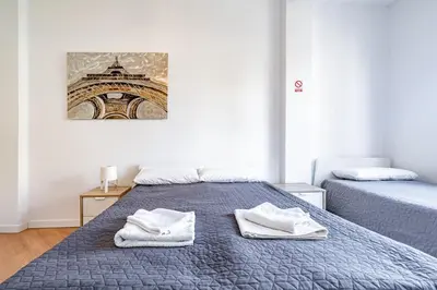 a bedroom with two beds with towels on them at Jardín Botánico Rooms in Valencia