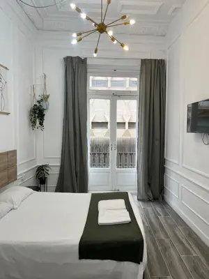 a bedroom with a large bed and a window at Star Home in Valencia