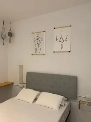 a bedroom with a bed with two pictures on the wall at Star Home in Valencia