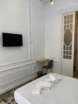 a bedroom with a bed and a tv on a wall at Star Home in Valencia