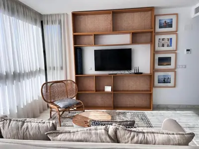 a living room with a couch and a tv at Valencia Luxury - Calma Beach Apartments in Valencia