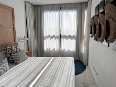a bedroom with a white bed and a window at Valencia Luxury - Calma Beach Apartments in Valencia