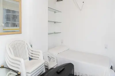 a room with a bed and two chairs and a desk at Florazar 3, 8º-B in Cullera