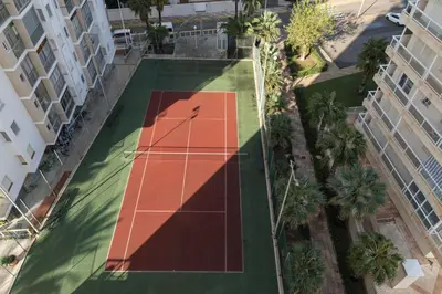 an overhead view of a tennis court between two buildings at Florazar 3, 8º-B in Cullera