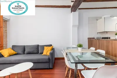 a living room with a couch and a table at Travel Habitat Plaza de la Virgen in Valencia