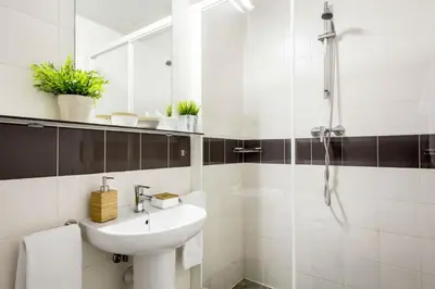 a white bathroom with a sink and a shower at Residencia Universitaria Resa La Concepción in Valencia