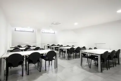 an empty room with tables and chairs in it at Residencia Universitaria Resa La Concepción in Valencia