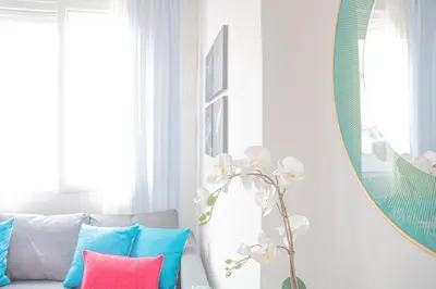a living room with a couch and a mirror at Lovely Modern Flat Valencia center in Valencia