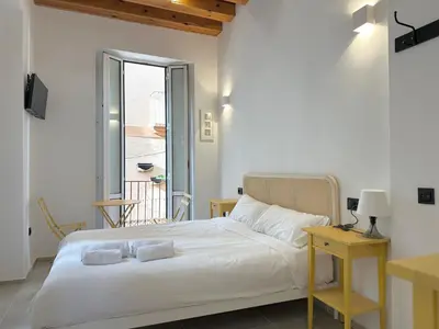 a bedroom with a white bed with two pillows on it at Mercat Suites in Valencia