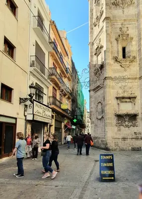 a group of people walking down a city street at Mercat Suites in Valencia