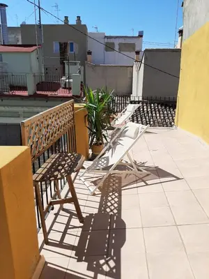 a row of benches sitting on a balcony at Mercat Suites in Valencia